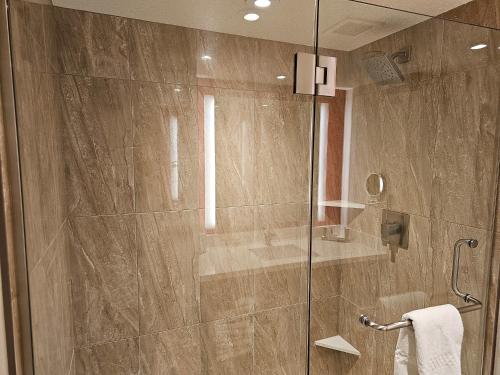 a shower with a glass door in a bathroom at Perfect Spot Unit by Horseshoe Casino Strip Las Vegas in Las Vegas