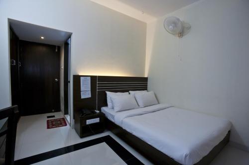 a bedroom with a white bed in a room at Hotel Holy Gate in Sylhet