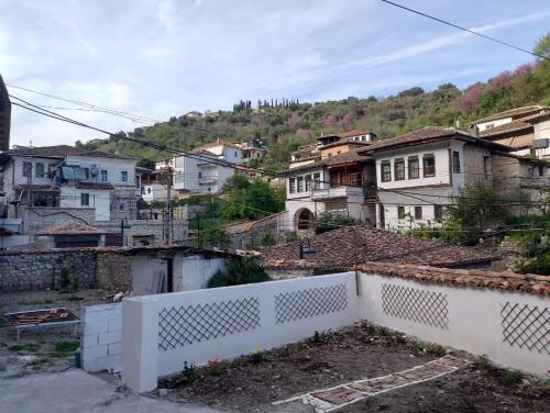 a group of buildings in a city with a white fence at Te MuzzeU Hostel in Berat