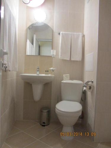a bathroom with a white toilet and a sink at Stephanovy Guest House in Sozopol