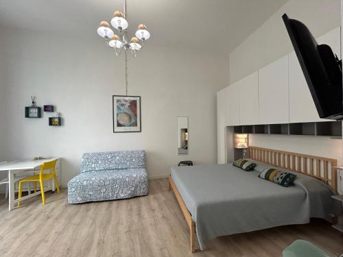 a bedroom with a bed and a table and a chair at Tabula Apartments in Olbia