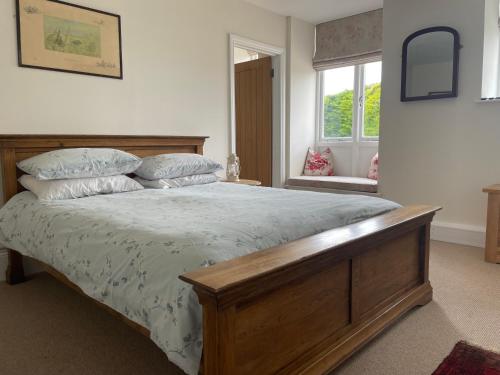 a bedroom with a large bed and a window at Scotland Lodge Farm, Stonehenge in Salisbury