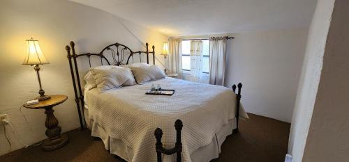 a bedroom with a large bed with a white bedspread at Lily Creek Lodge in Dahlonega