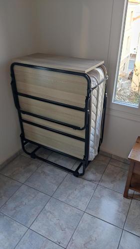 a towel rack in the corner of a room at Angelos Rooms in Mytilini