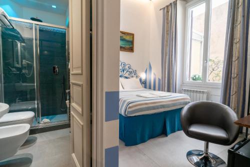 a small room with a bed and a bathroom at Teresa Rooms & Suites in La Spezia
