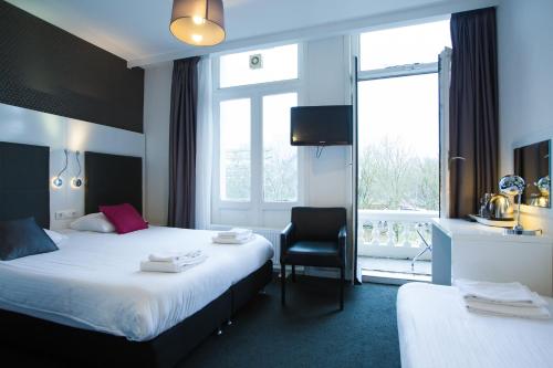 Cama o camas de una habitación en Hotel Vossius Vondelpark