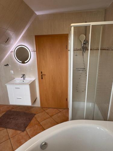 a bathroom with a tub and a sink and a shower at Ferienhaus am Norden in Neumünster