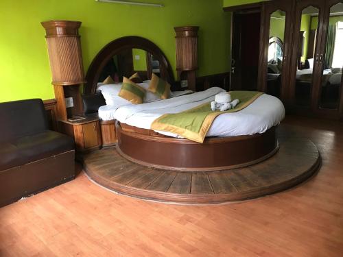 a large bed in a room with a round bedvisor at Kamya INN, Puri in Puri