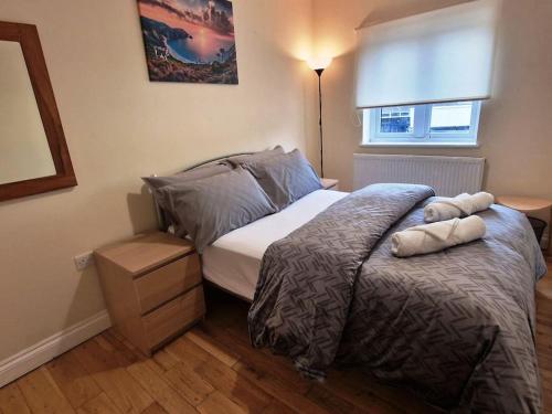 a bedroom with a bed with two pillows on it at 2 Bedroom Flat close to centre in Bristol