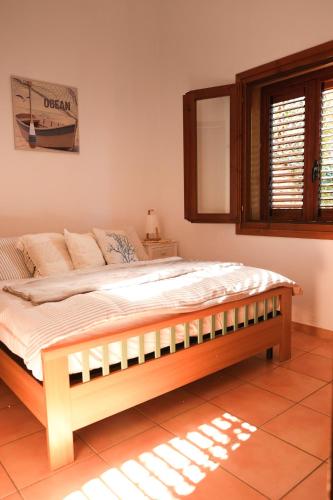 a bedroom with a large bed in a room at Casa Adriana - Costa Paradiso in Costa Paradiso