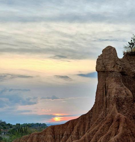 a rock formation with the sunset in the background at Hostal Sol de Verano Doña Lilia in Villavieja