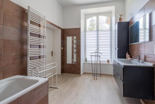 a bathroom with a tub and a sink at Abbaye de l'Etanche - 2 chambres d'hôtes - Un cadre naturel exceptionnel - 