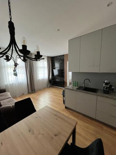 a living room with a table and a kitchen at ANETT Apartament nr 4 in Sulęcin