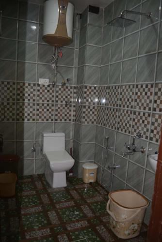 a dirty bathroom with a toilet and a sink at Gautam Villa Home Stay Varanasi in Varanasi