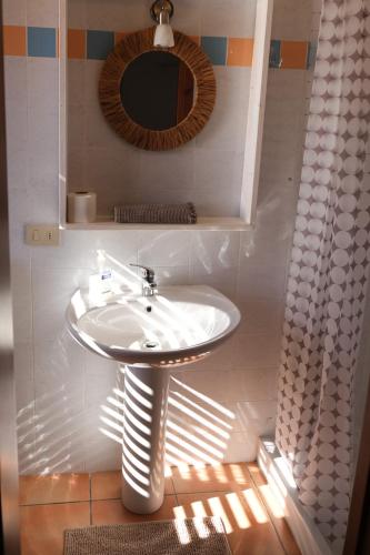 a bathroom with a sink and a mirror at Casa Adriana - Costa Paradiso in Costa Paradiso