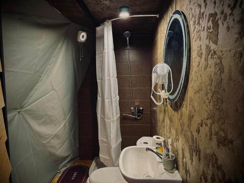 a small bathroom with a toilet and a sink at Vardzia Glamping in Vardzia