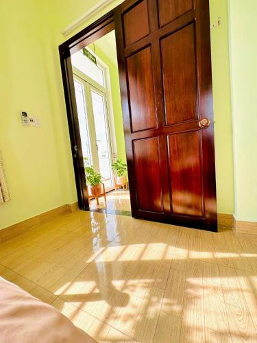 a wooden door in a room with a wooden floor at GUEST HOUSE PHÚ XUÂN in Thôn Lại Thê
