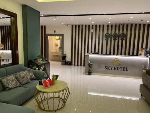 a lobby of a sky hotel with a couch and a table at Sky Hotel in Aqaba