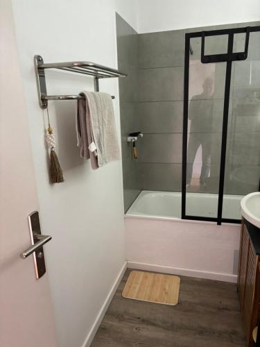 uma casa de banho com uma banheira e um lavatório em Plein Soleil em Saint-Jean-de-Monts