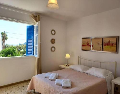 a bedroom with a bed with two towels on it at The house of Nikos and Katerina 2 in Andros