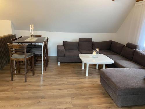 a living room with a couch and a table at Sunny apartment in Åbybro