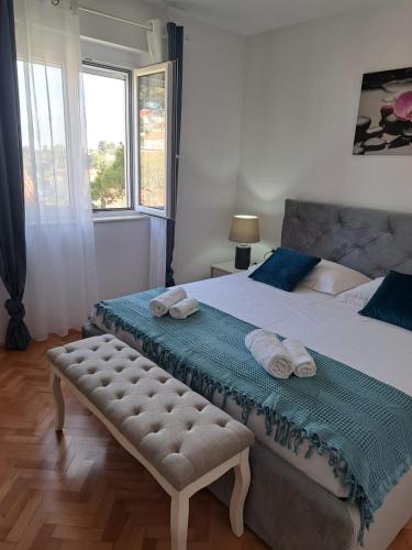 a bedroom with a large bed with towels on it at La Petite Maison in Splitska