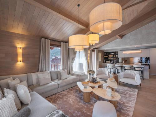 un salon avec un canapé et une table dans l'établissement Chalet de Luxe avec Sauna et Jacuzzi, Proche Pistes et Centre de Courchevel - FR-1-563-142, à Courchevel
