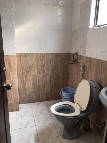 a bathroom with a toilet and a sink at Groot Home Stays Varanasi in Varanasi