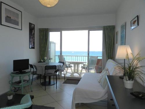 un salon avec un canapé et une table avec une télévision dans l'établissement Studio avec terrasse et parking au Lavandou, accès direct plage - FR-1-251-804, au Lavandou