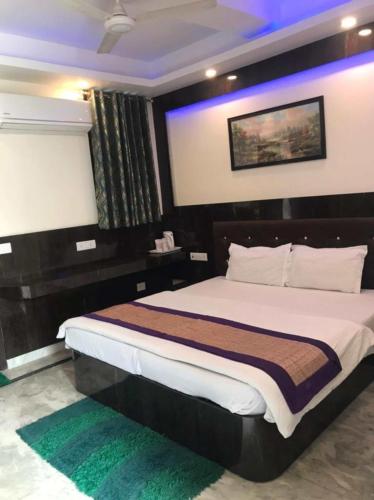 a bedroom with a large bed in a room at Groot Home Stays Varanasi in Varanasi