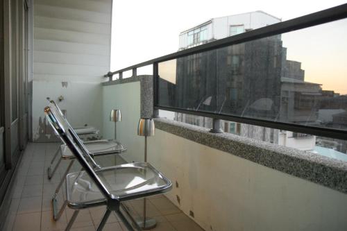 a bathroom with two chairs on a balcony at 聖水洞民宿성수동 in Tainan