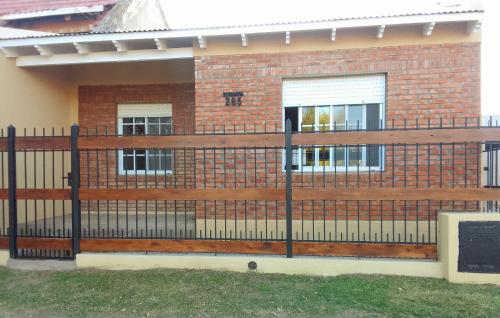 a black fence in front of a house at La Pausa in Carhué