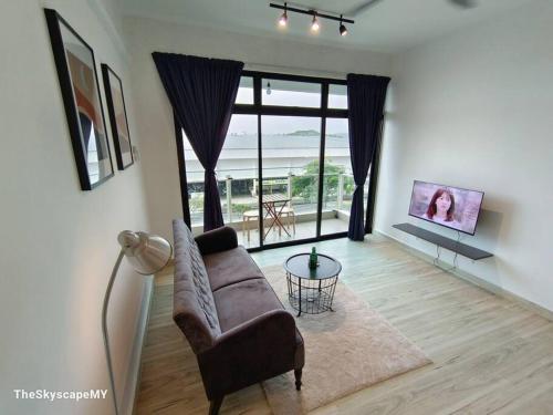 a living room with a couch and a glass table at 【HOT!】 JB Muji White Theme - Space & Comfy Suite in Johor Bahru