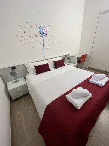 a bedroom with a large bed with two towels on it at La Lirica rooms in Verona