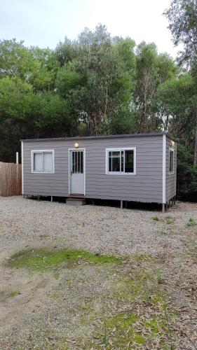 a small house is parked in a yard at Tiny house, casa de playa océan park in Ocean Park