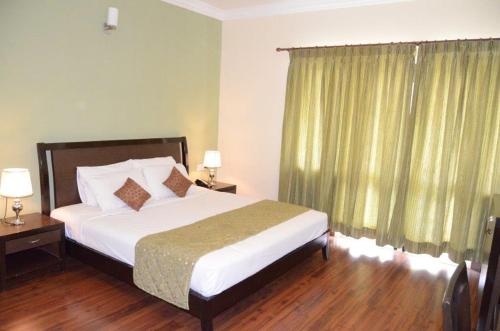 Ένα ή περισσότερα κρεβάτια σε δωμάτιο στο Trinity Suites