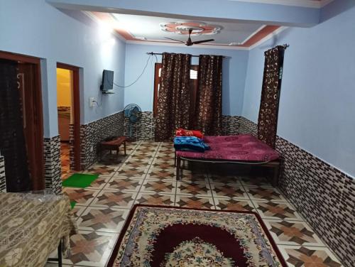 a living room with a couch and a fireplace at Badal Home Stay @ Jawalaji in Kangra
