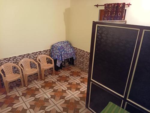 a dining room with chairs and a table and a table and chairs at Badal Home Stay @ Jawalaji in Kangra