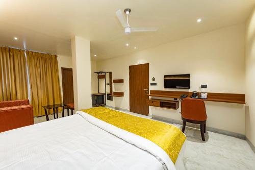 a bedroom with a large white bed and a desk at Uphills boutique hotel in Kallar Vattiyar