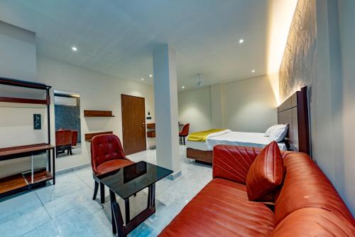 a living room with a couch and a bed at Uphills boutique hotel in Kallar Vattiyar