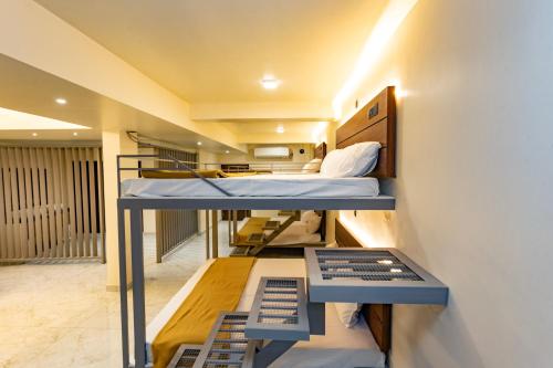 a small room with two bunk beds in it at Uphills boutique hotel in Kallar Vattiyar