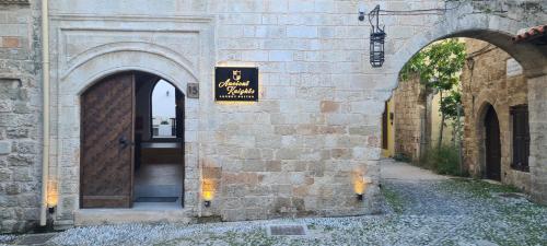 an entrance to a building with a sign on it at Ancient Knights Luxury Suites in Rhodes Town