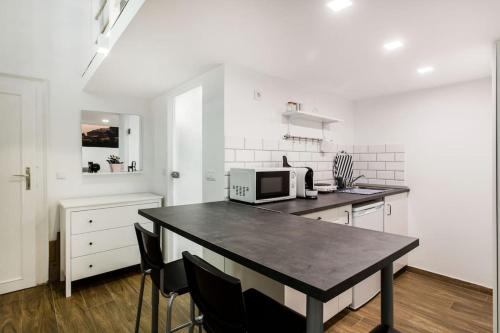 a kitchen with a table with a microwave on it at 57 Steps from the Basilica in Budapest