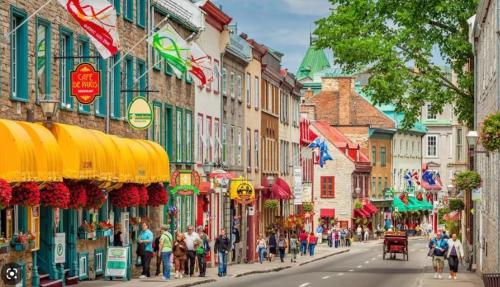 a group of people walking down a street in a city at 22#31 Chemin du Hameau - Studio in Stoneham