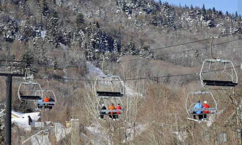 a group of people riding on a ski lift at 22#31 Chemin du Hameau - Studio in Stoneham