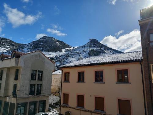 a view of mountains from a city with buildings at HOTEL RURAL ORQUIDEA in Velilla del Río Carrión