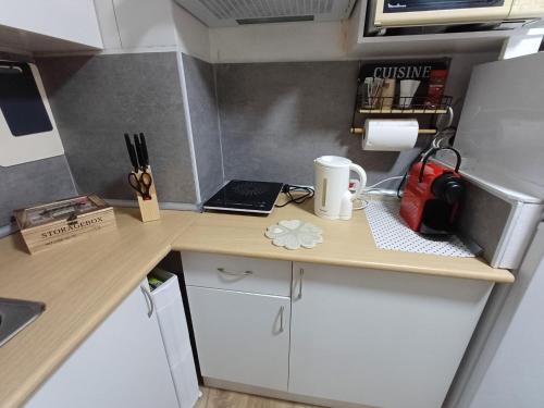 a small kitchen with a desk with a laptop and a cup at Alicante Denia Apartments in Alicante