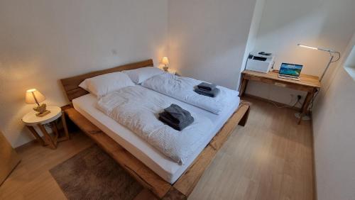 a bedroom with a bed with two pillows on it at Apartment ZerMo in Zermatt