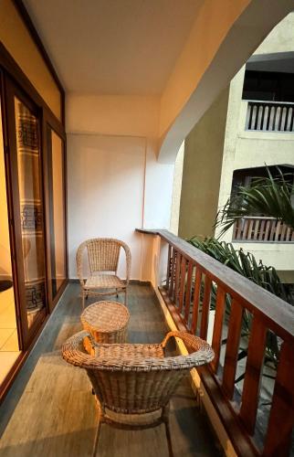 a balcony with a chair and a table at Diani Sun Beachfront Studio in Ukunda