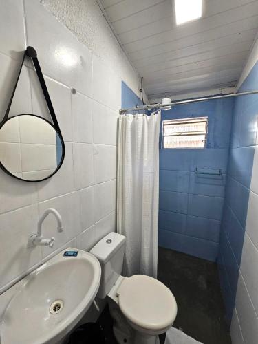a bathroom with a white toilet and a sink at Cantinho da Nonna in Morretes